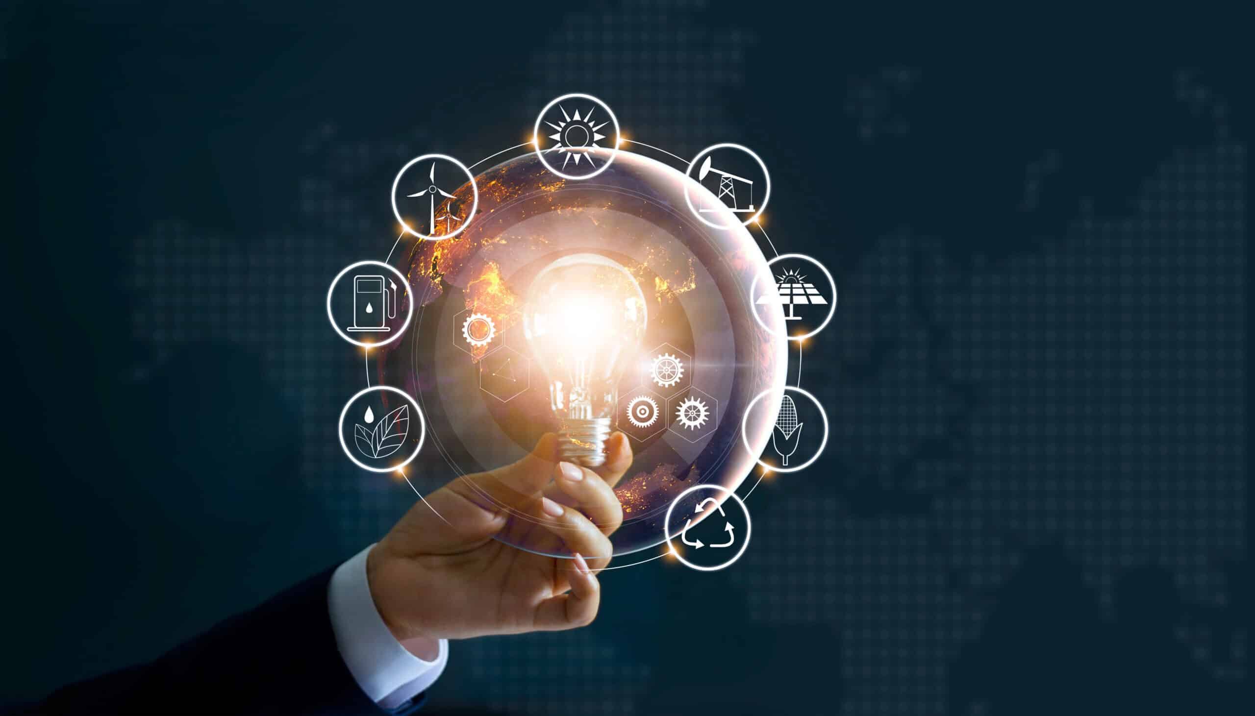 Hand holding light bulb in front of global show the world’s consumption with icons energy sources for renewable, sustainable development. Ecology concept. Elements of this image furnished by NASA. electrical engineering
