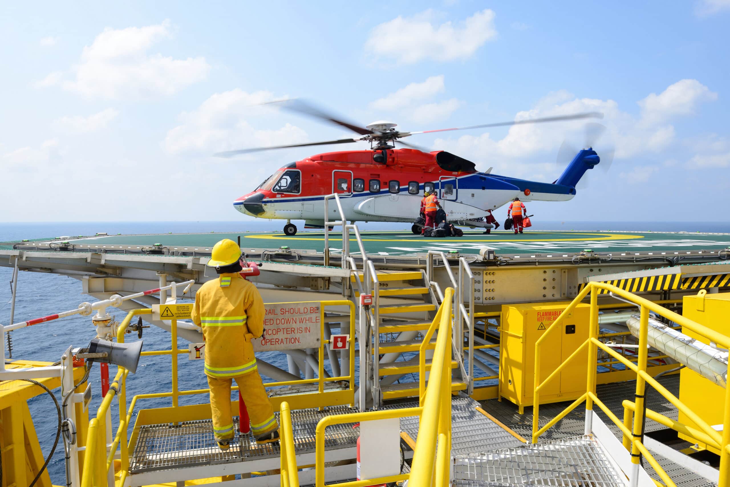 The landing officer are loading baggage of passenger to helicopt project engineer